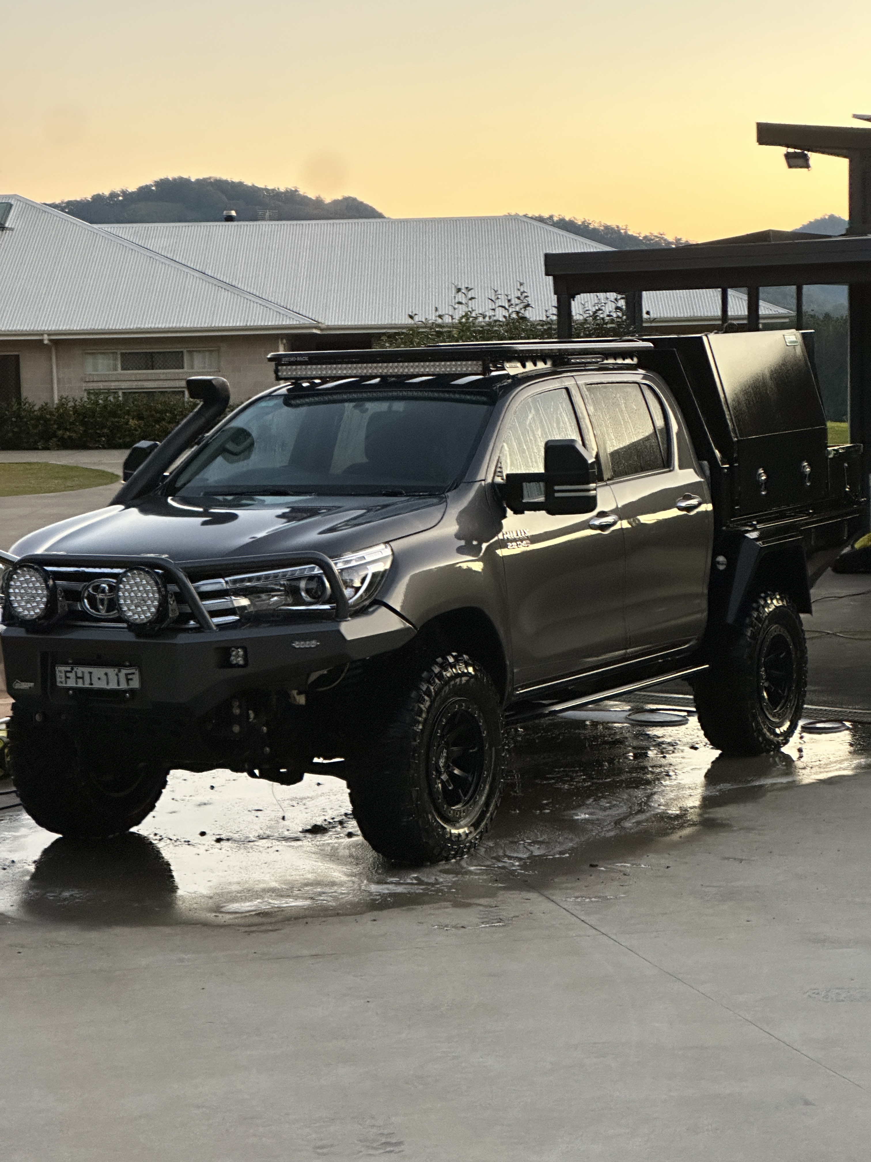 A bronze Hilux at dusk, freshly washed