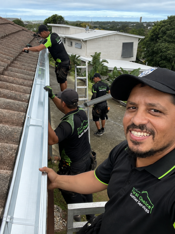 The First Choice Gutter Services team on a roof fitting a new gutter