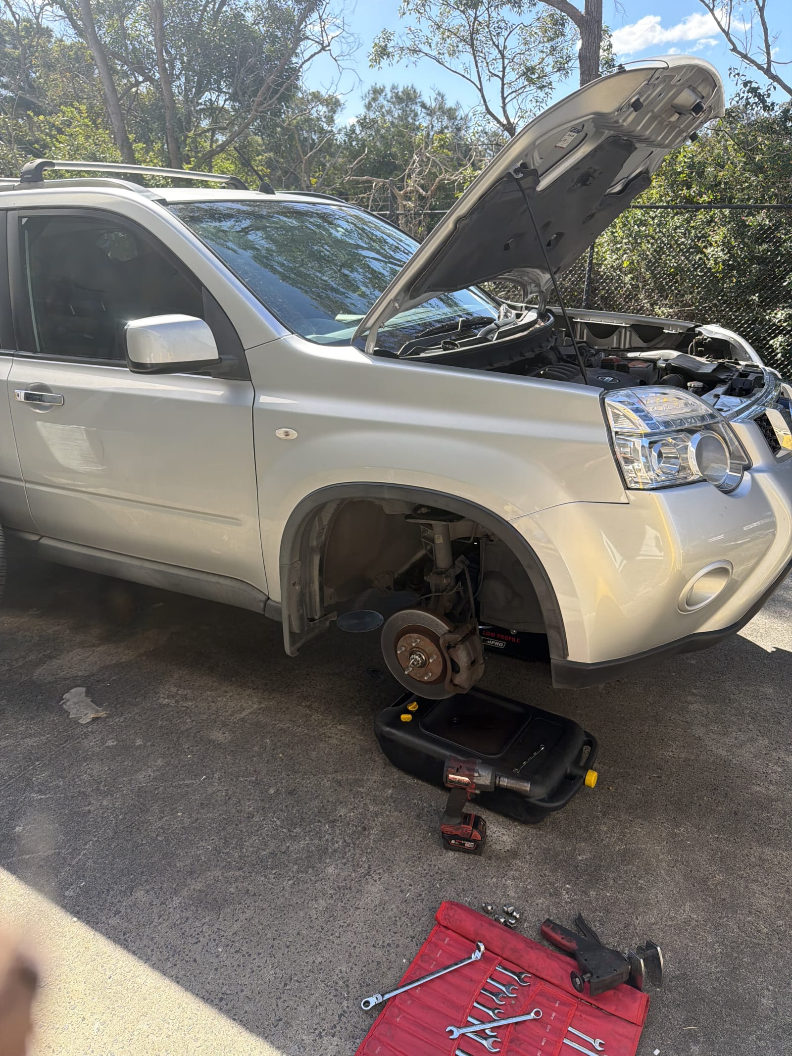 Nissan X-Trail with the front wheel off and the brake disc exposed