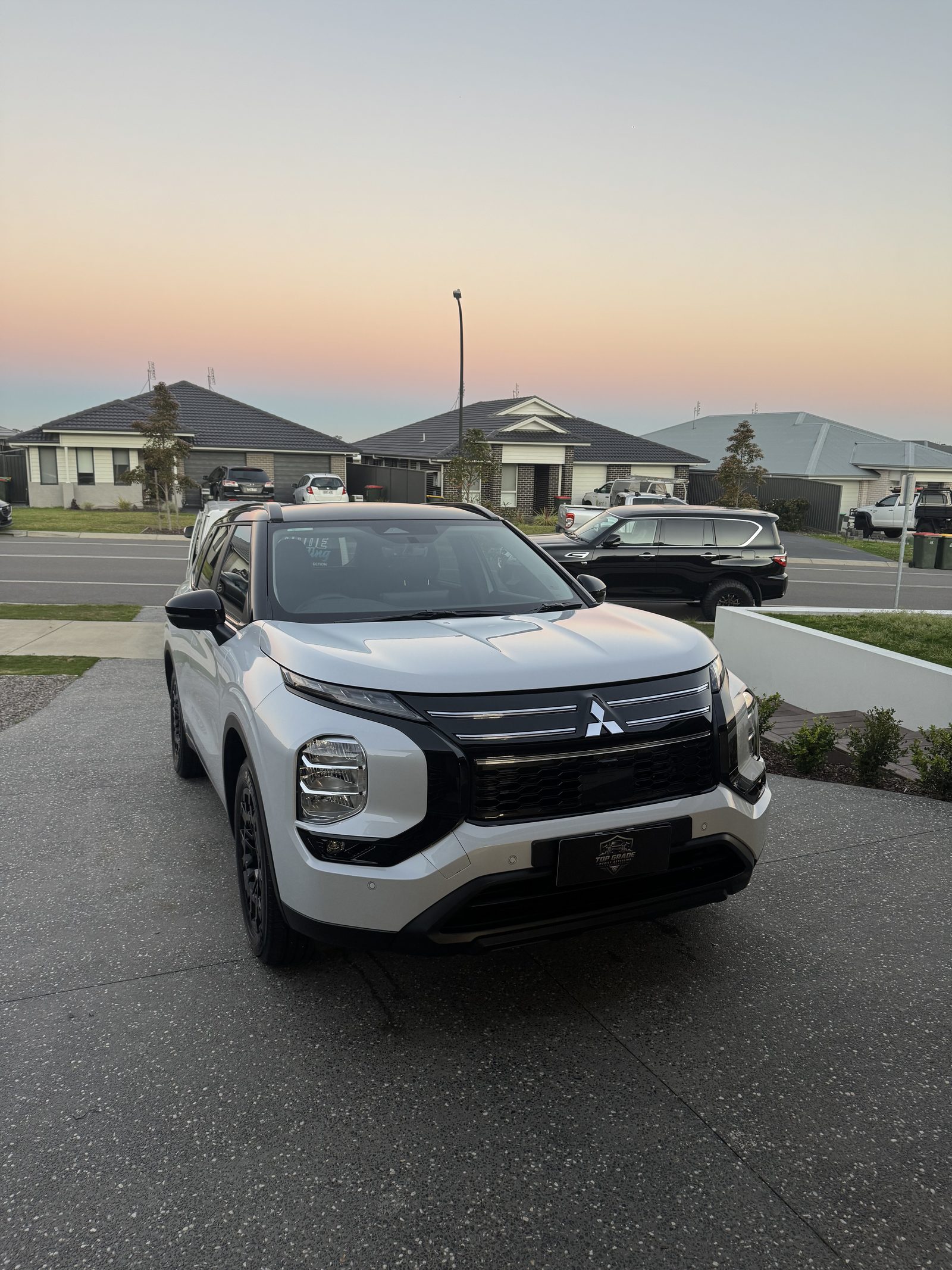 White Mitsubishi SUV detailed by Top Grade Mobile Detailing
