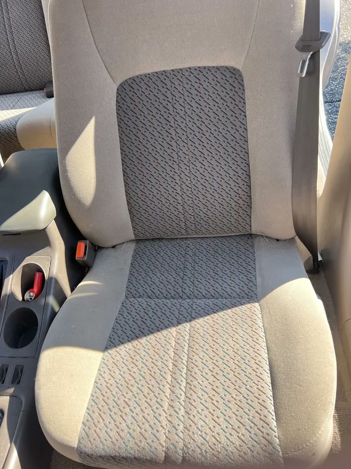 Front seat with staining across the base before detailing