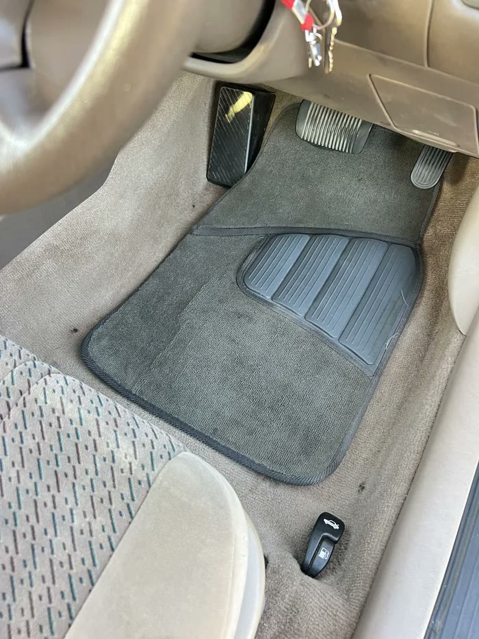 The same footwell and mat after a deep clean