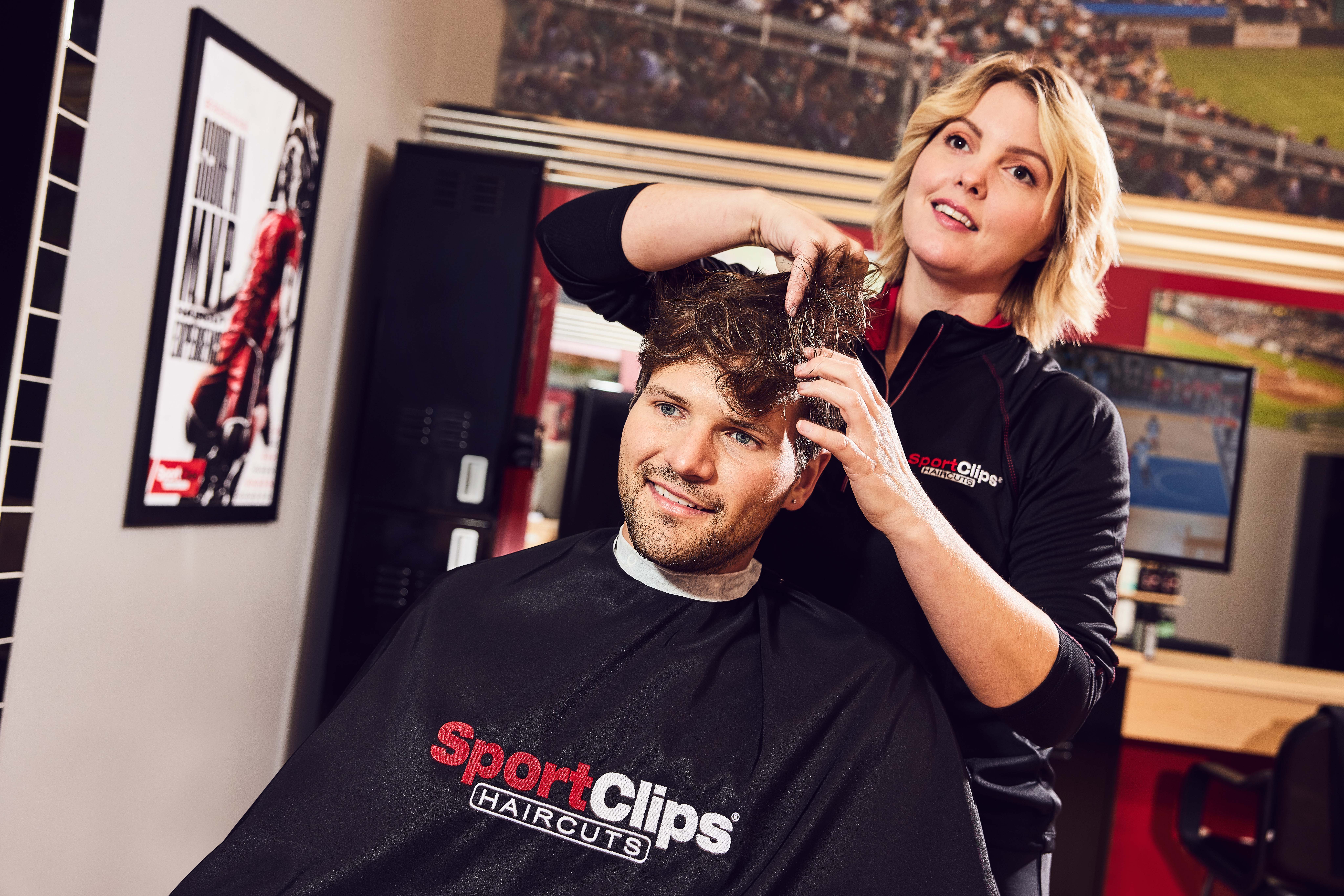 Sport Clips stylist giving a men's haircut