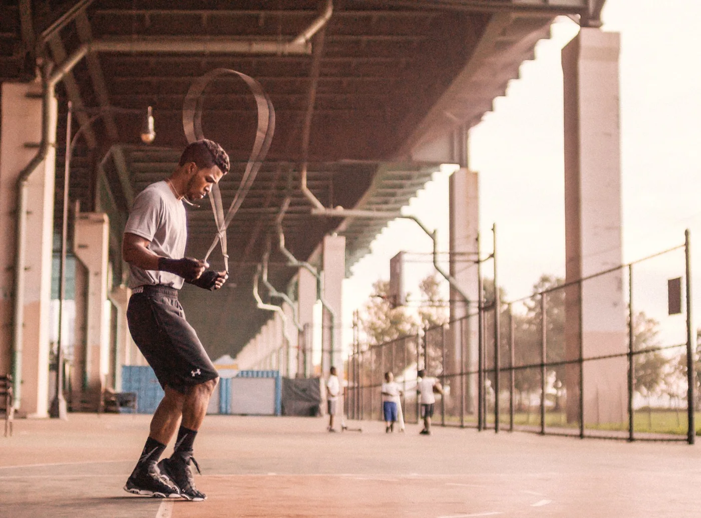 Ralph skipping rope outdoors under a bridge