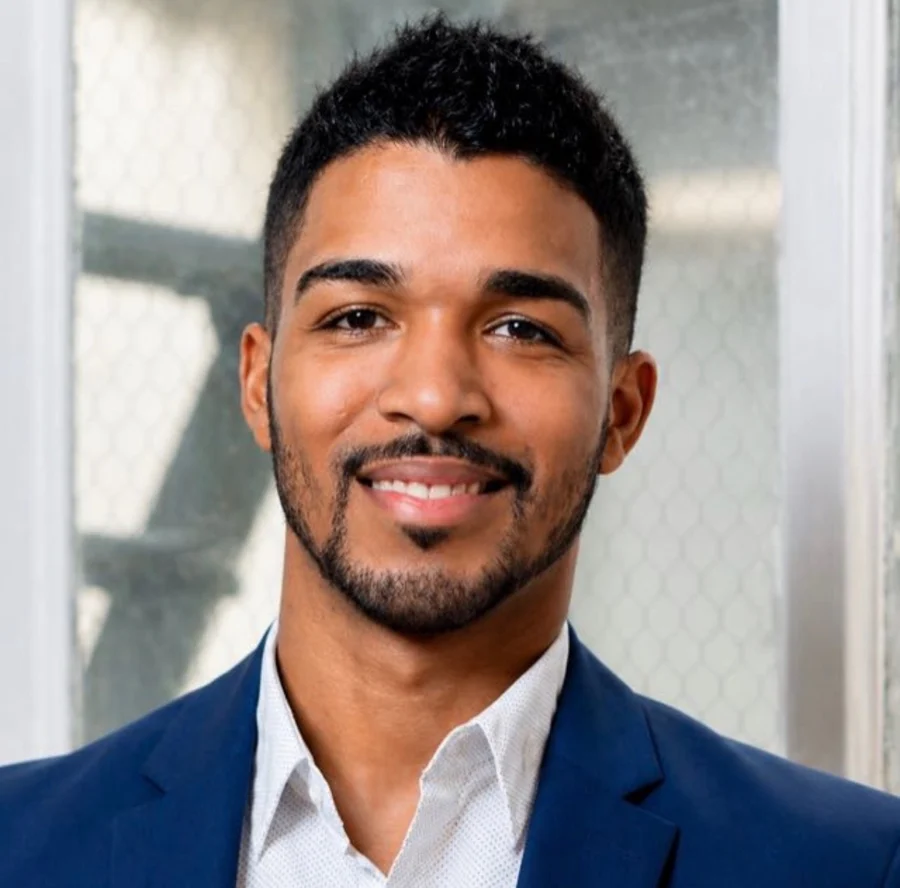 Ralph Llenas Ruiz, smiling, in a blue suit