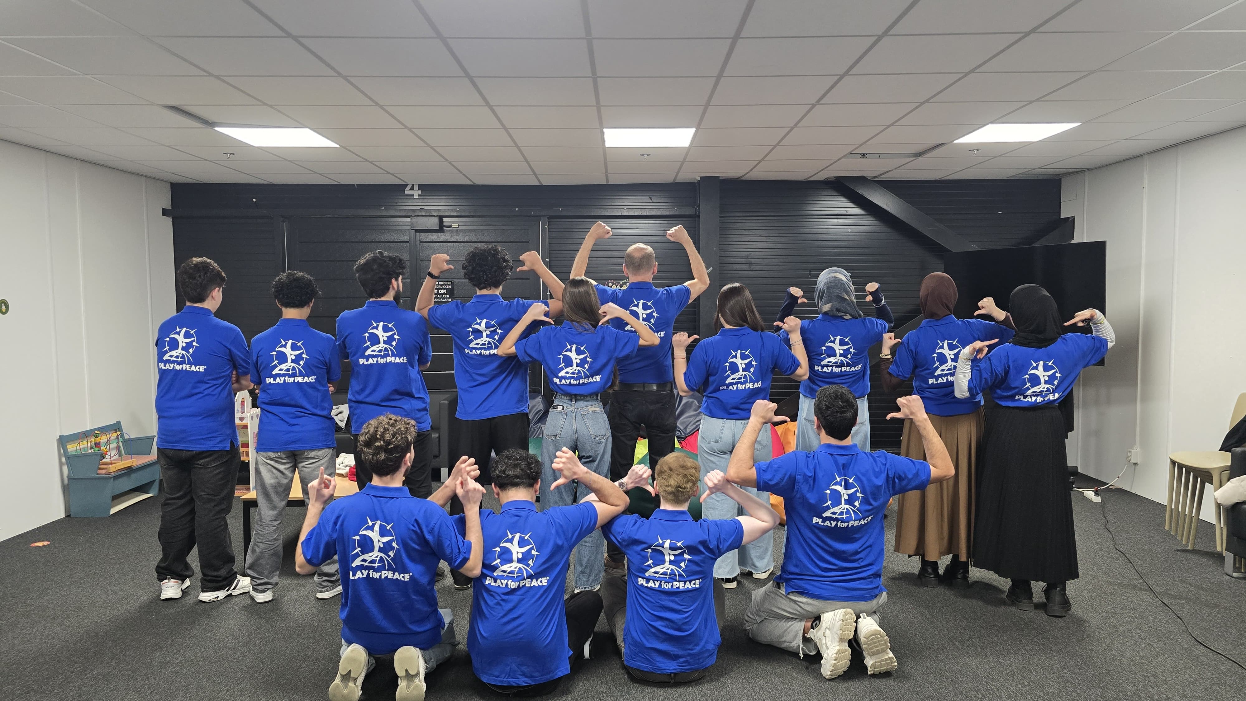 Children and residents at Assen asylum seekers centre welcoming the Play4Peace team home with sparklers and cheers after winning the Encouragement Prize