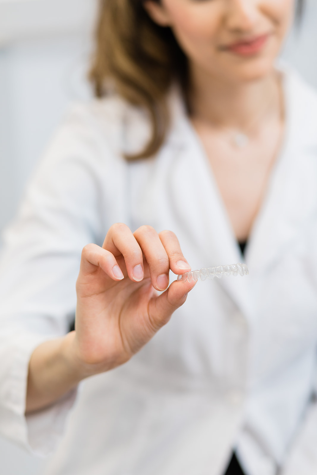 Patient holding Invisalign aligner tray