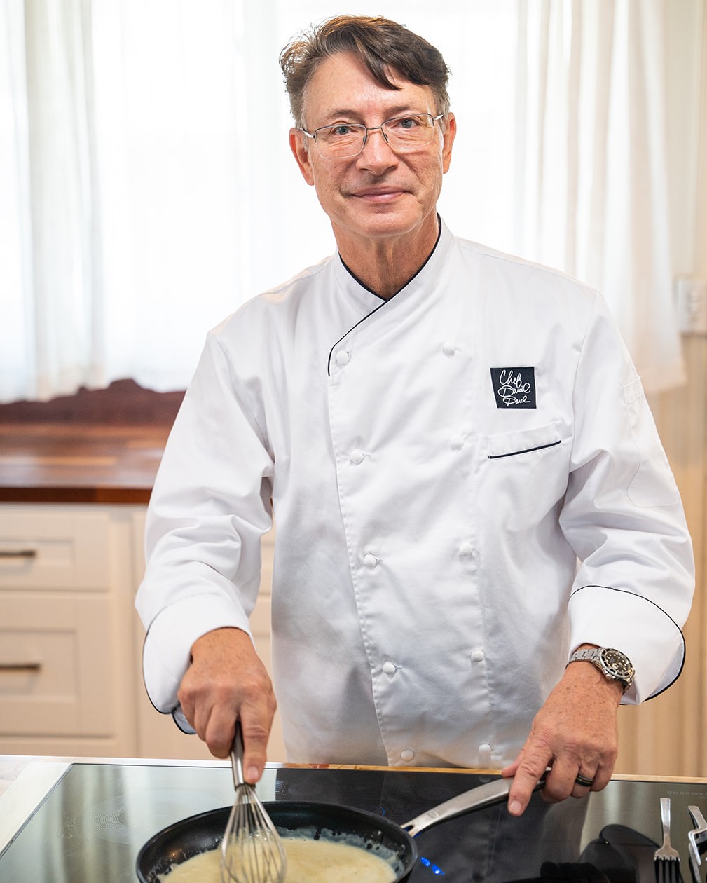 Chef David Paul preparing a custom anniversary dinner course in his Honolulu kitchen