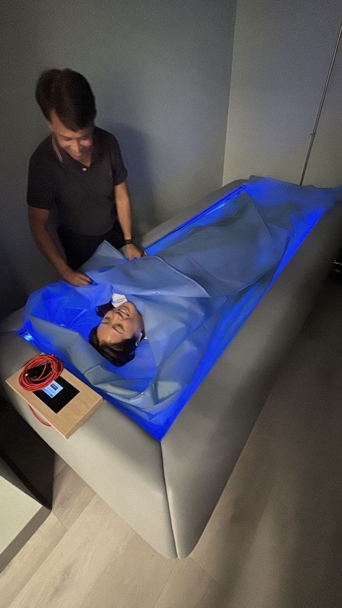 A member laughing during a dry cold plunge session with Dr. Tim