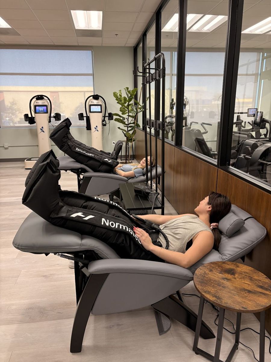 Members relaxing in compression recovery chairs