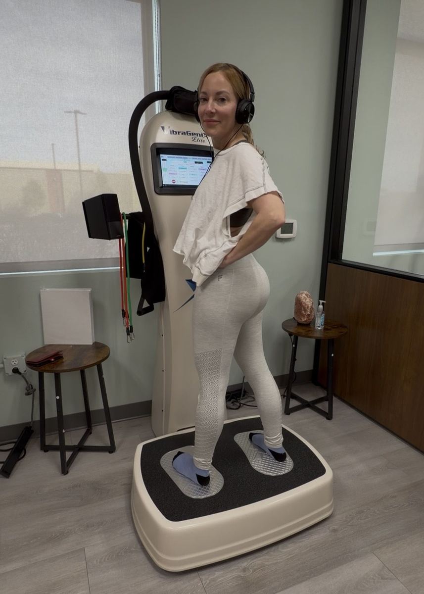 A member smiling during a vibration therapy session