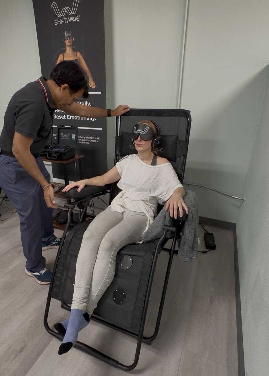 Dr. Tim guiding a member through a Shiftwave relaxation session