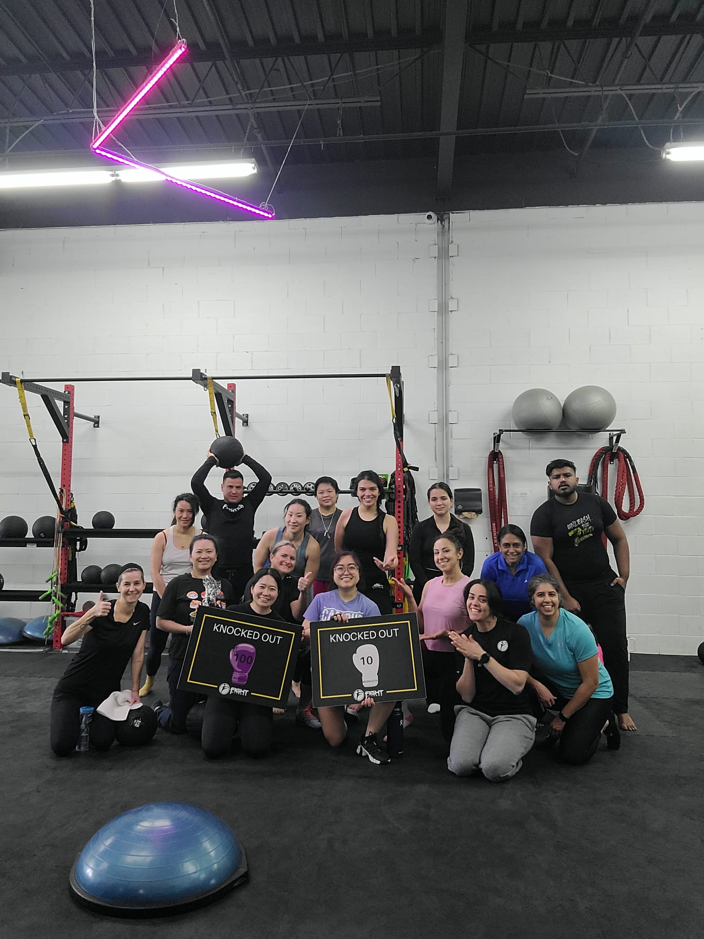 Fight Fitness group class photo with Nelly and members after training session celebrating achievements.