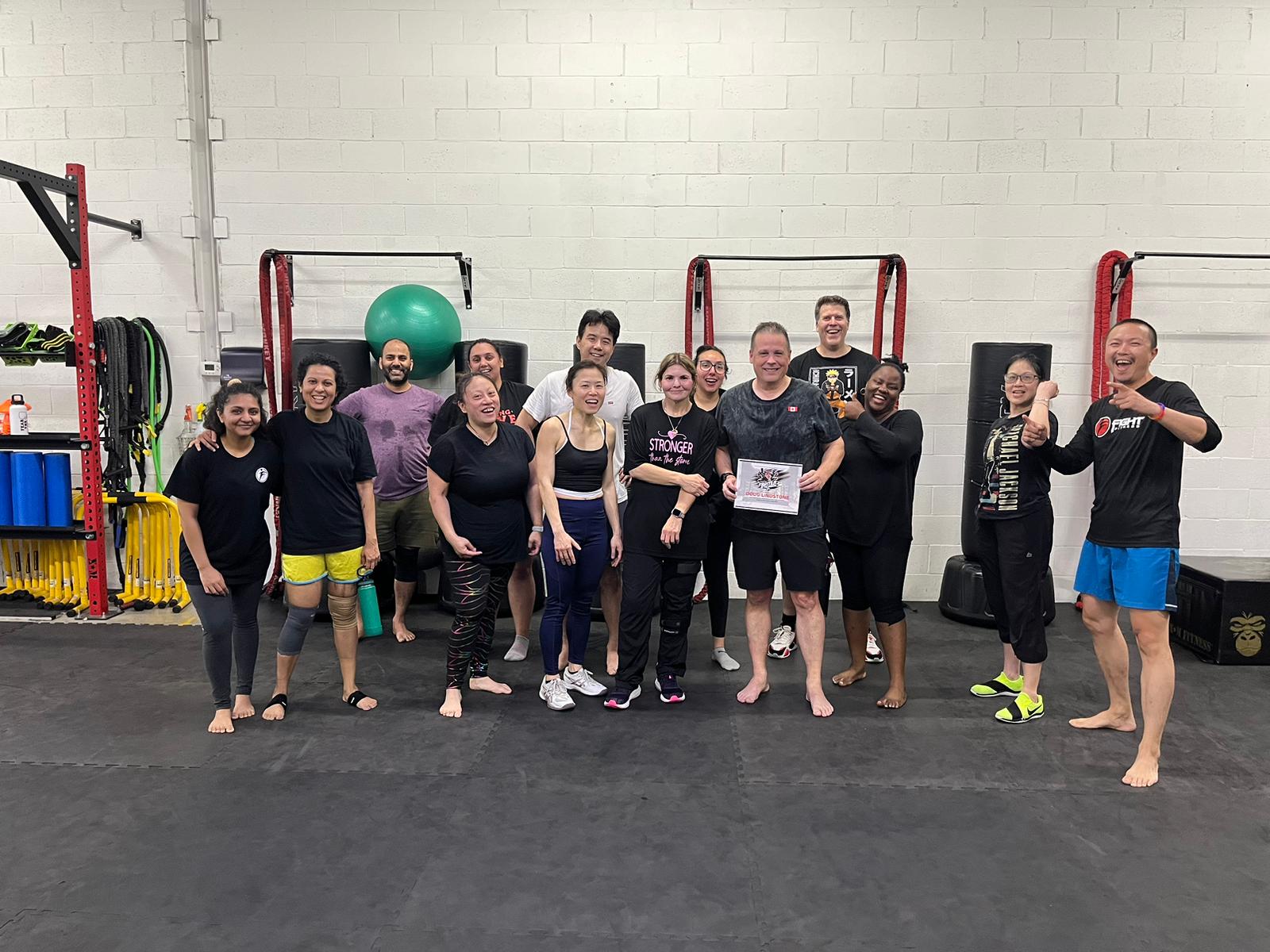 Group fitness class environment at Fight Fitness showing community-driven training and accountability system