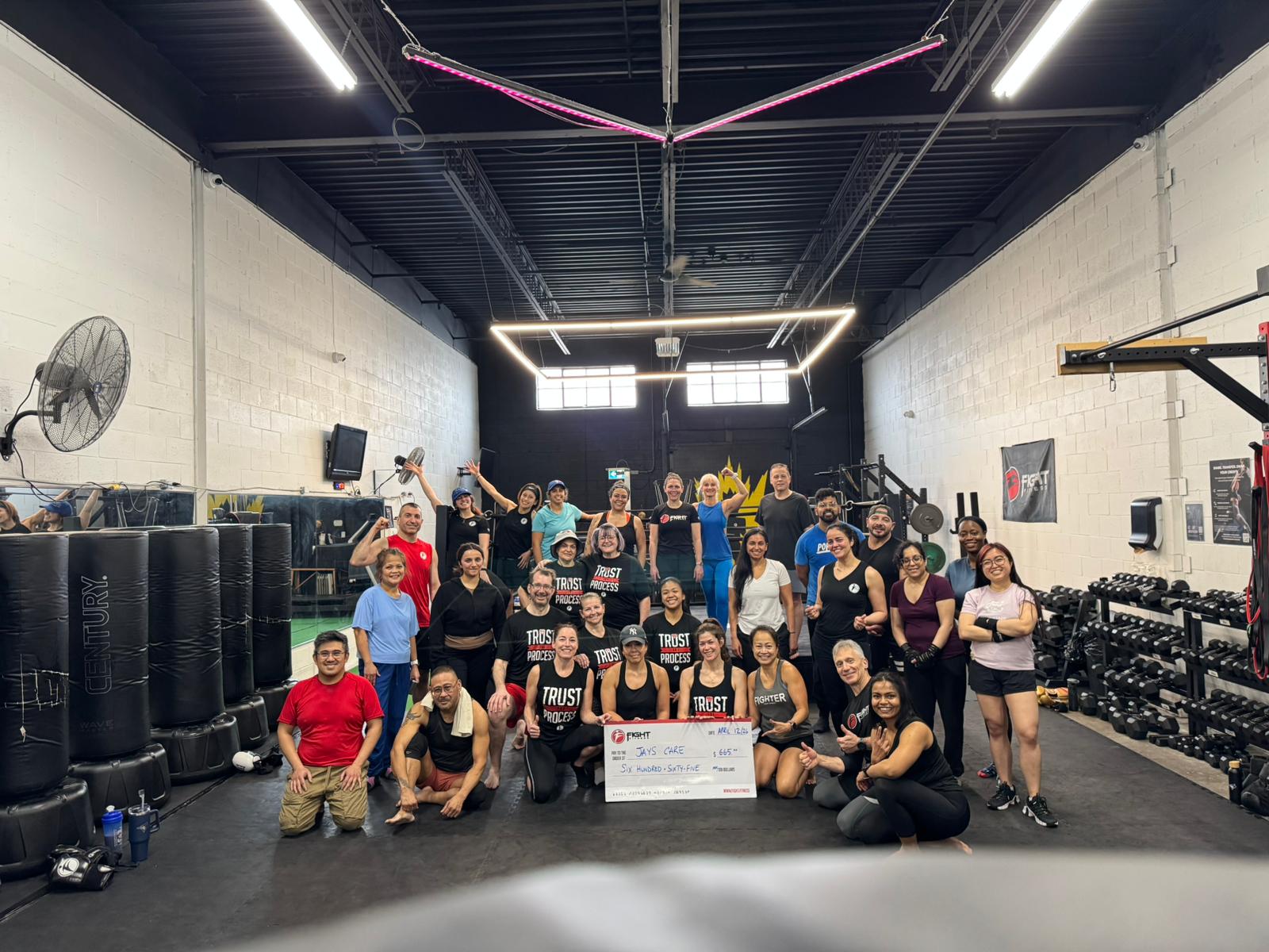 Fight Fitness members presenting a $665 donation cheque to Jays Care Foundation after a packed charity workout in memory of Stephen “Super Steve” Osbourne