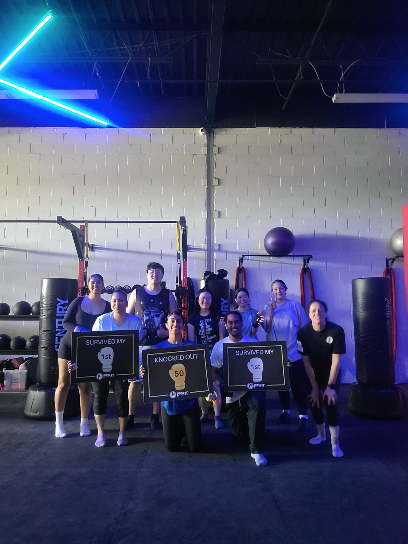 Fight Fitness Markham coach Nelly "The Beast" Alzeer training members on the gym floor during a group kickboxing class