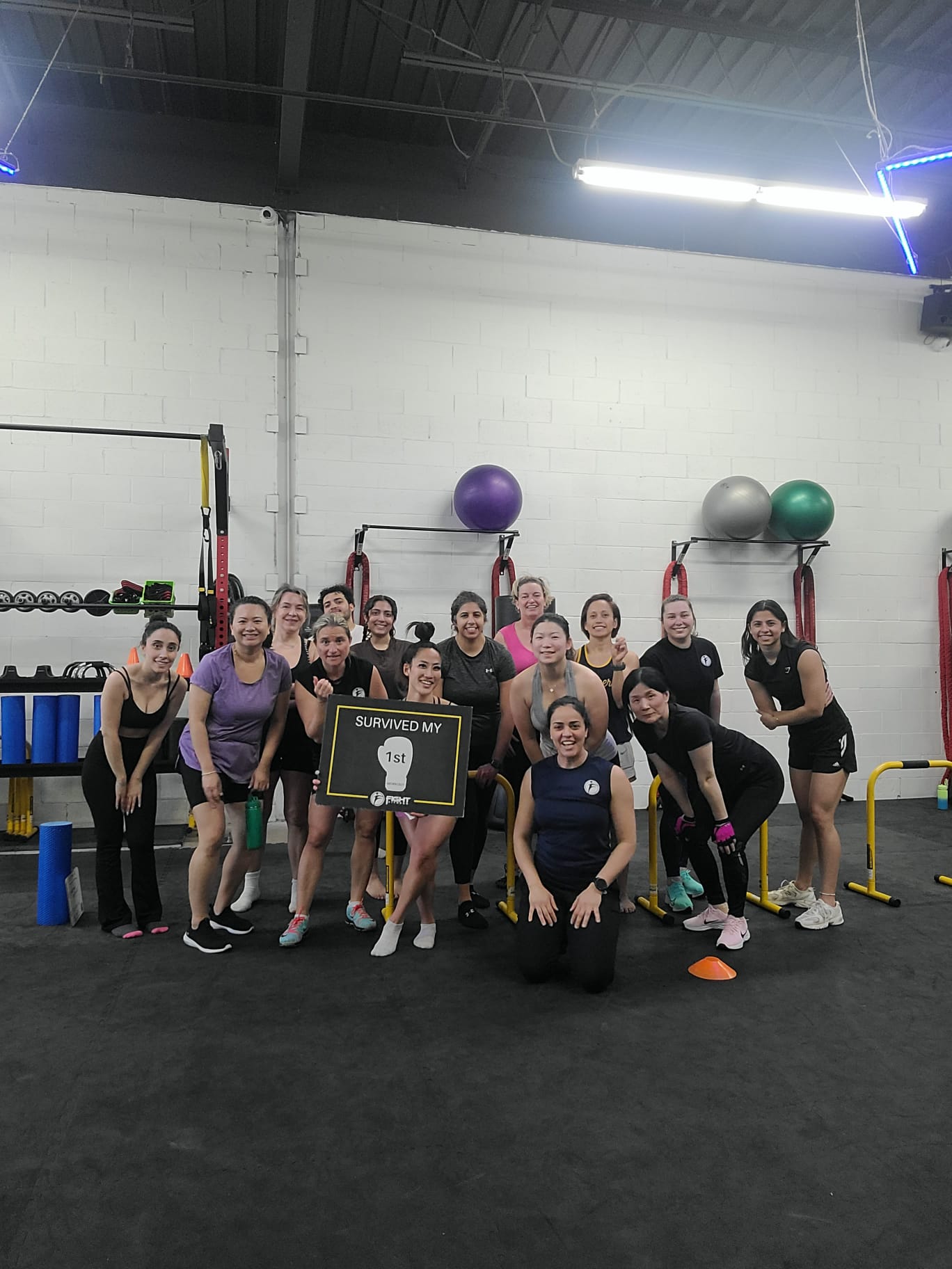 Nelly "The Beast" Alzeer celebrating her Dragon of the Month award with Fight Fitness Markham members and coaches