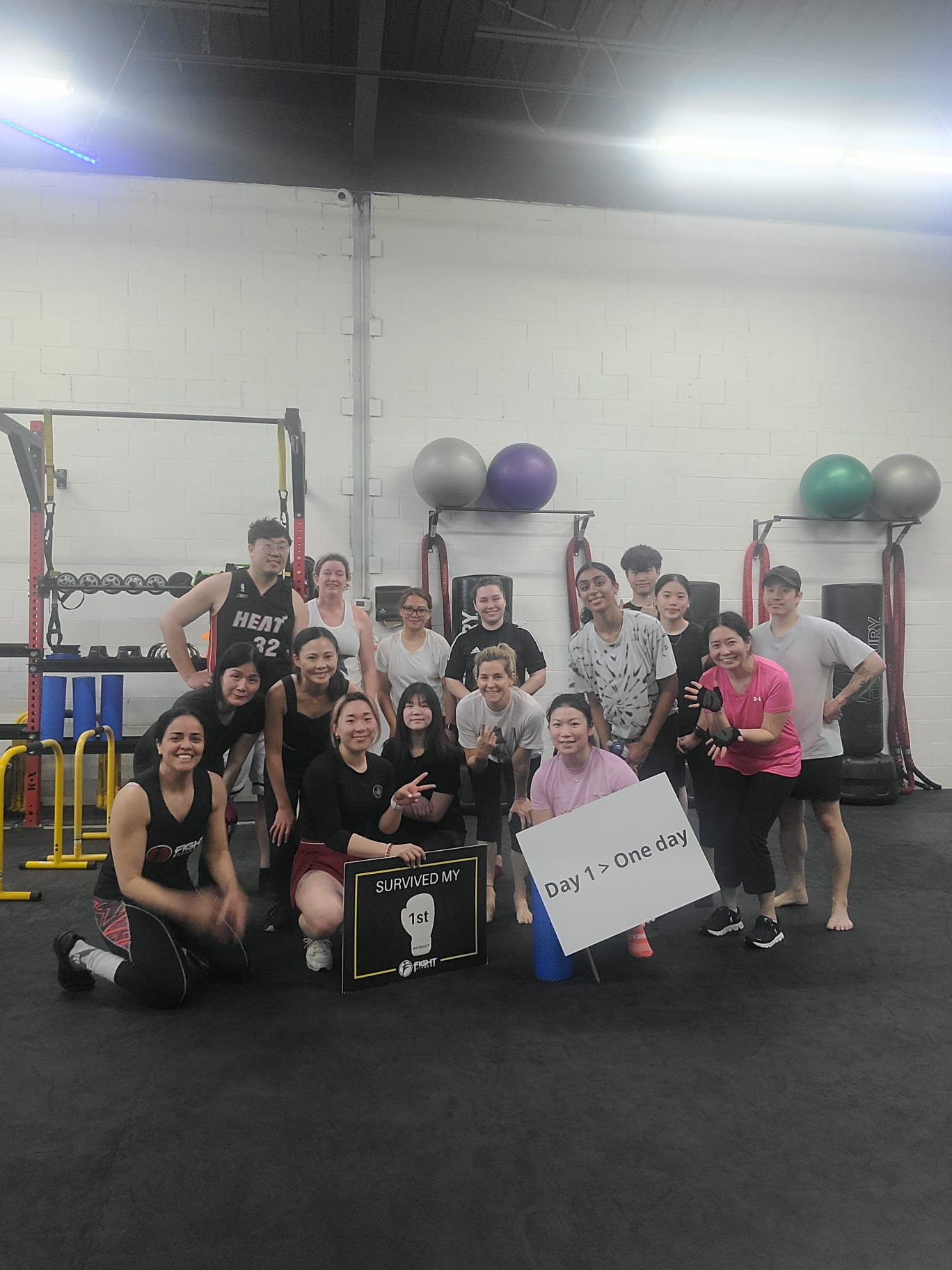 Fight Fitness coach Nelly Alzeer high-fiving members after an intense group fitness class at Fight Fitness Markham