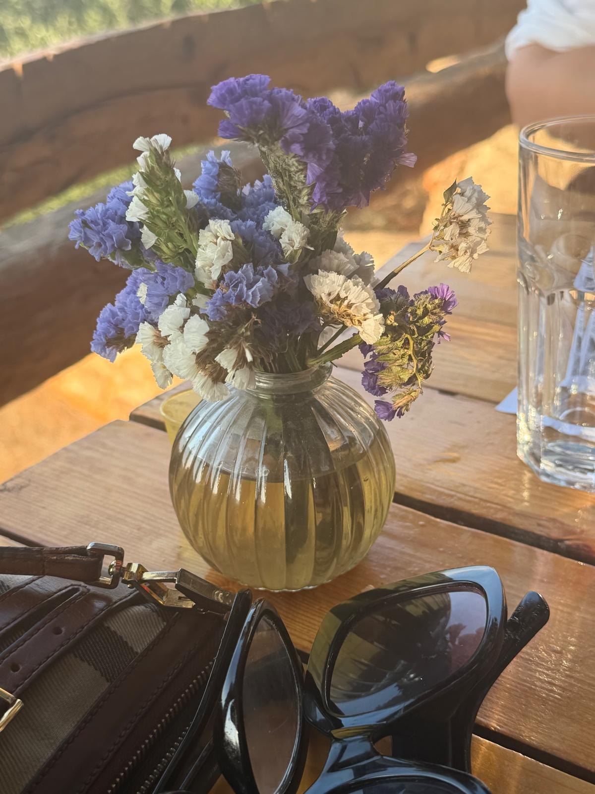 Dried wildflowers in a glass vase on the table