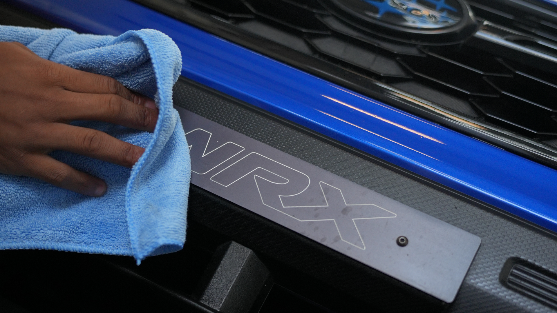 Ceramic coating applied to blue vehicle door sill