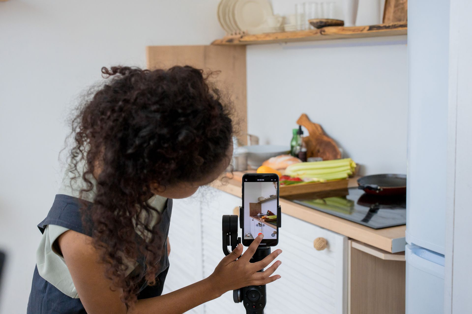 Creator filming food prep on a phone gimbal