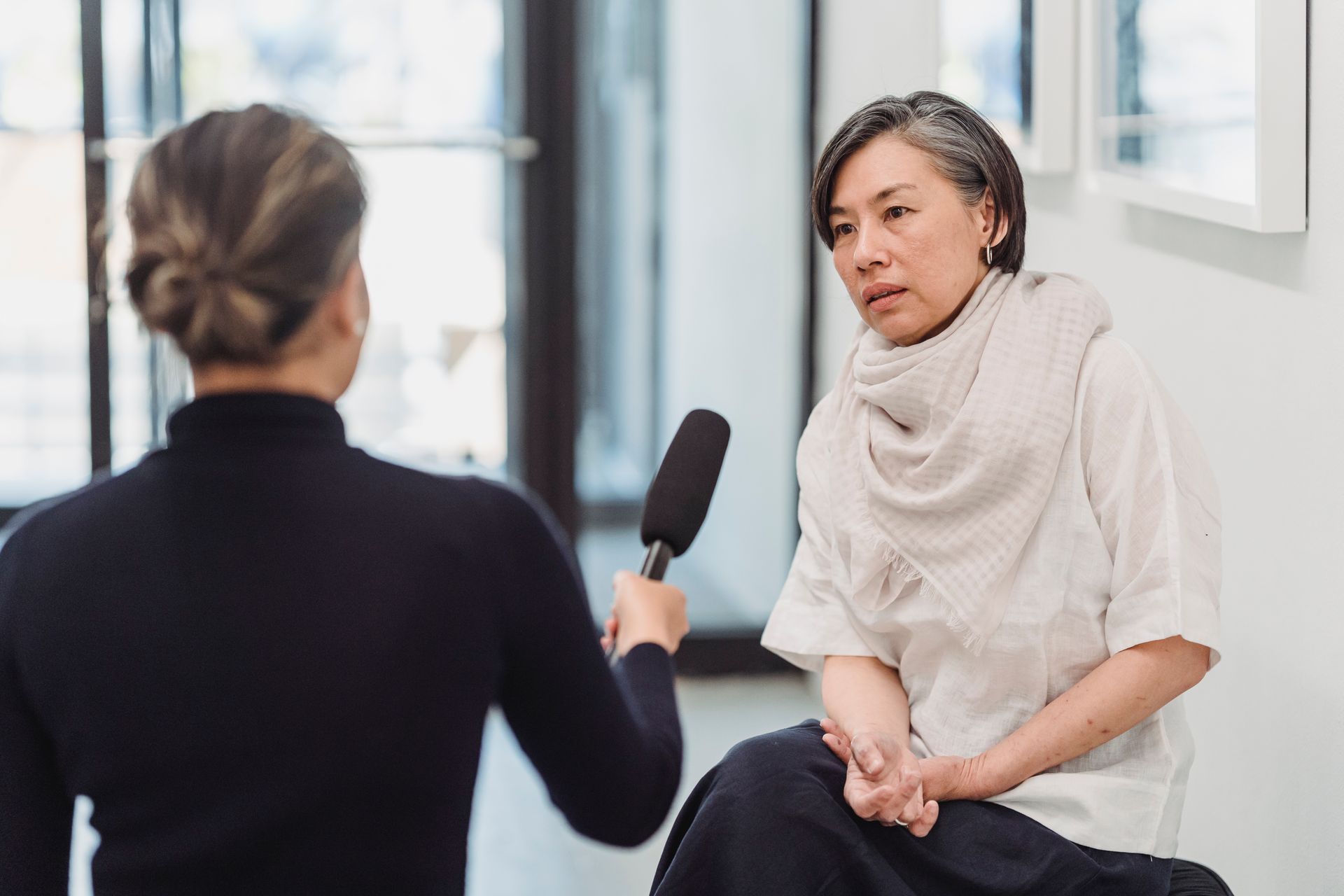 Interviewer talking with a business owner on camera