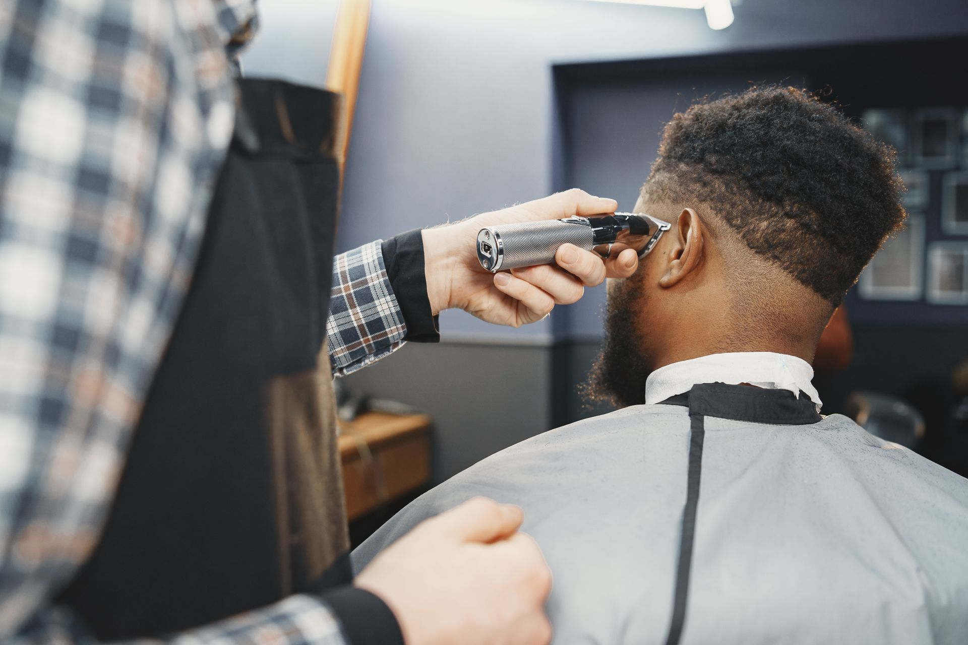 Barber fading a client's haircut