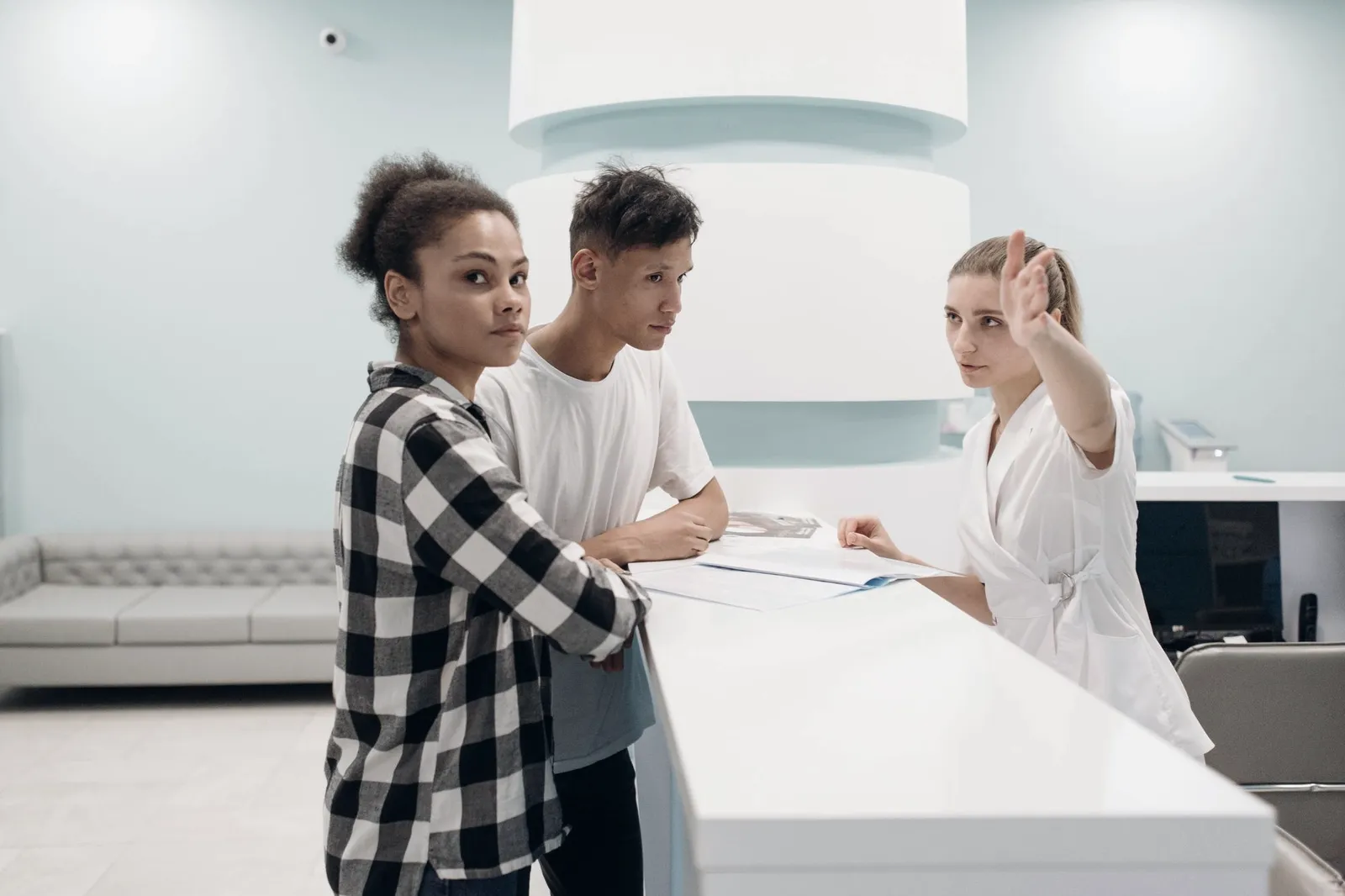 Patients checking in at a clinic reception desk