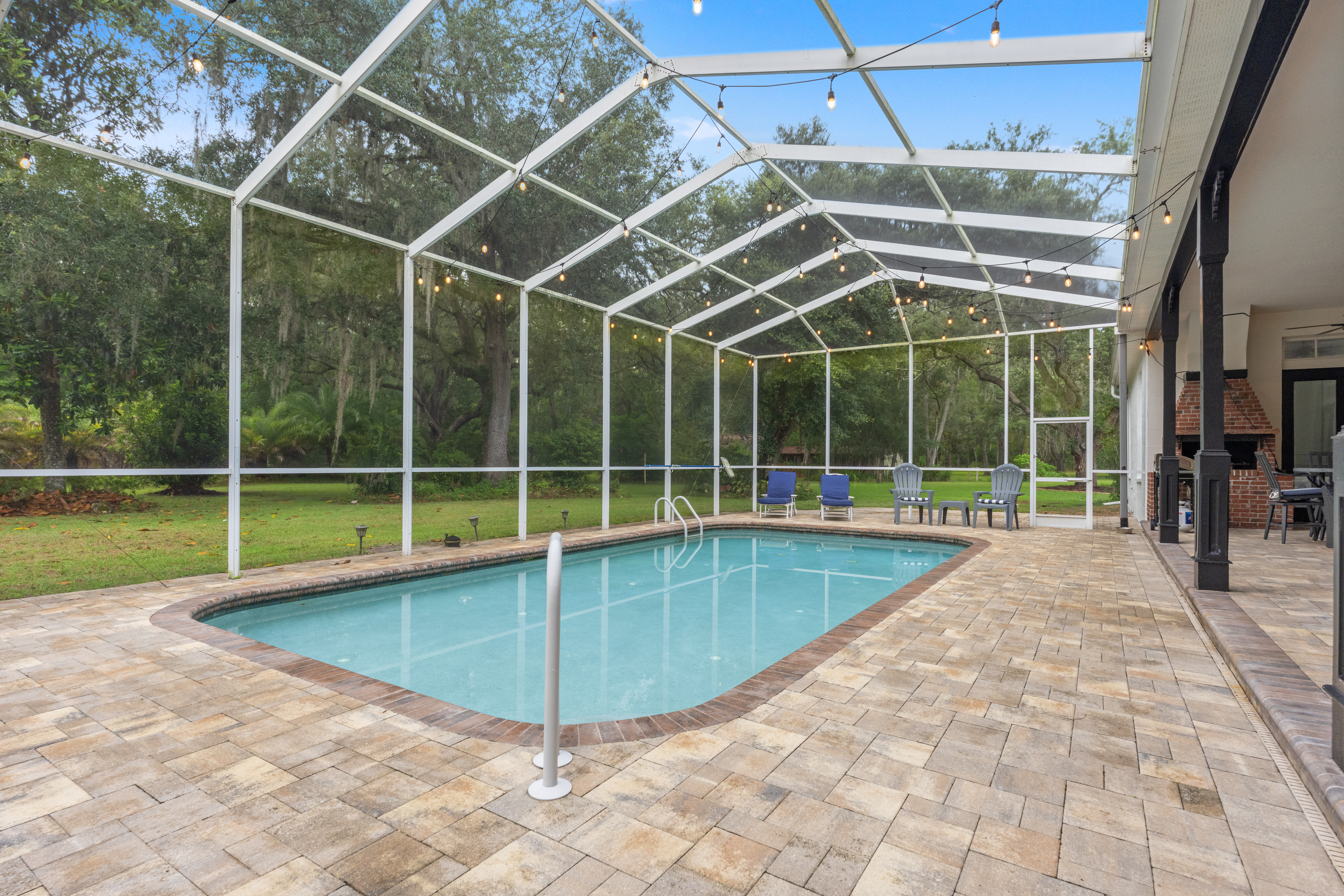 Saltwater pool and backyard patio space at dusk