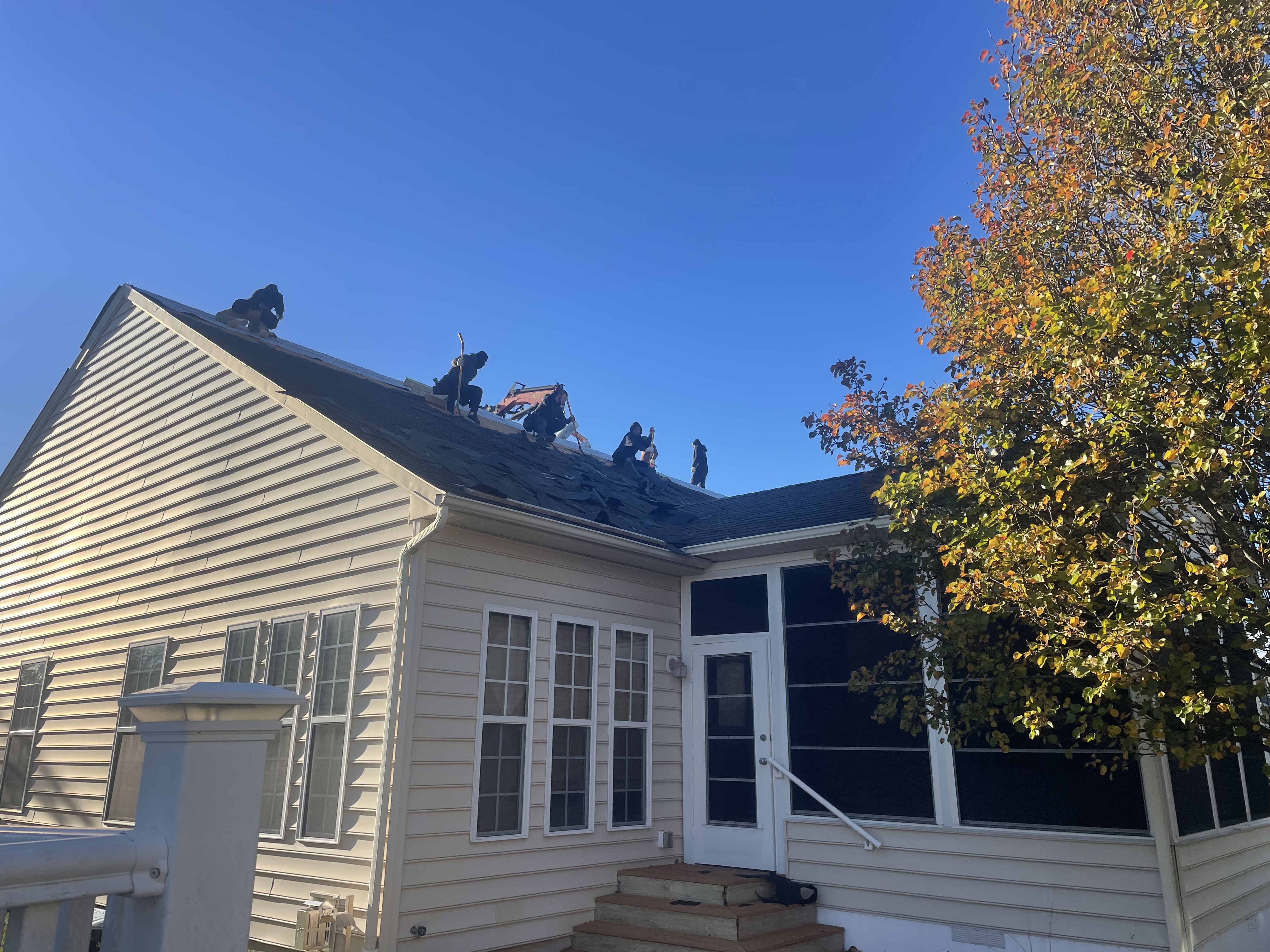 Crew on roof with materials