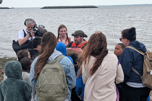 Students exploring the Staten Island shoreline near Living Breakwaters during a hands-on field experience