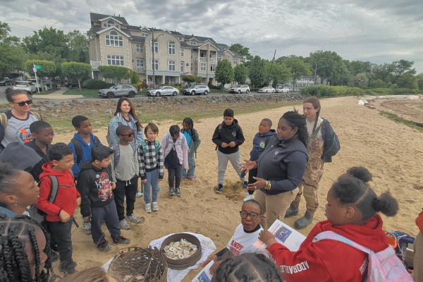 Students learning about oyster restoration, marine ecosystems, and Sandy Ground history from Judy Moody Lewis, President of The Sandy Ground Historical Society
