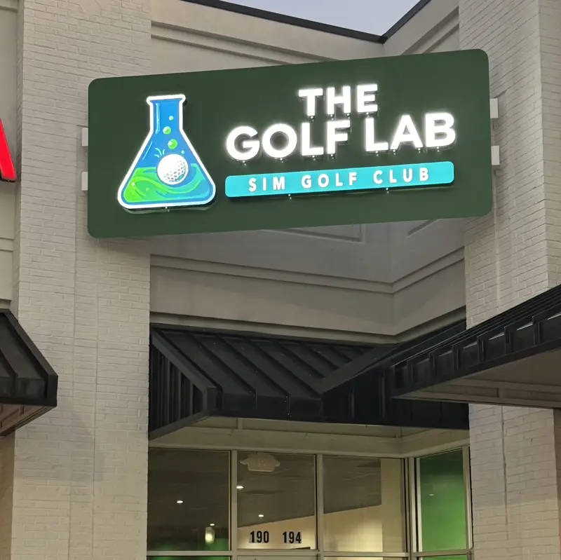 The Golf Lab storefront with its lit green sign
