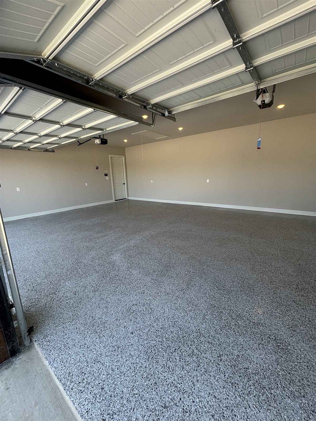 Grey flake epoxy garage floor in a Midlothian, TX home