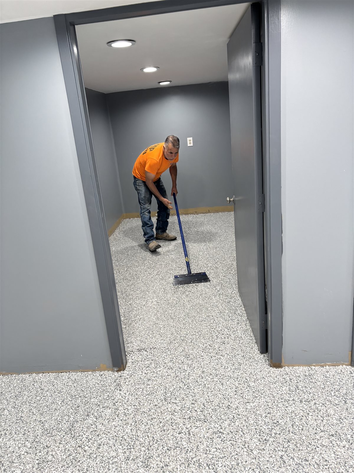 Signature Epoxy Floors crew finishing a flake epoxy floor in a Midlothian hallway