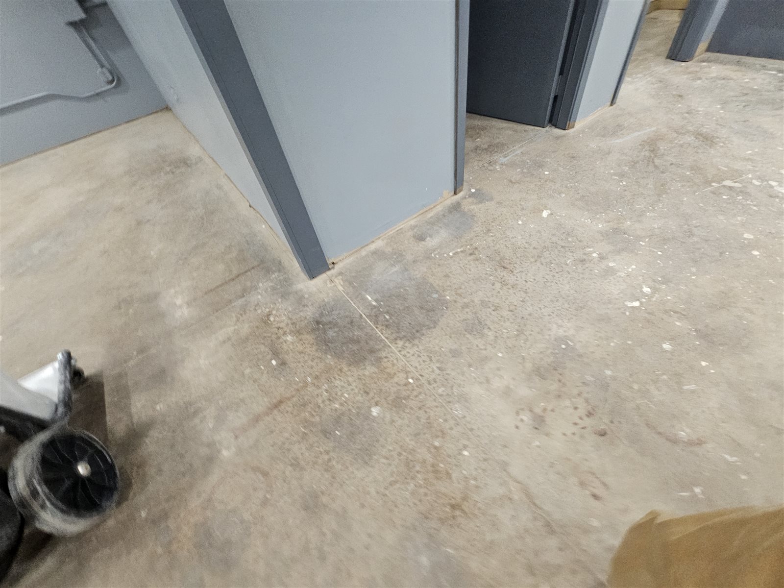 Stained bare concrete floor in a Midlothian commercial building before epoxy