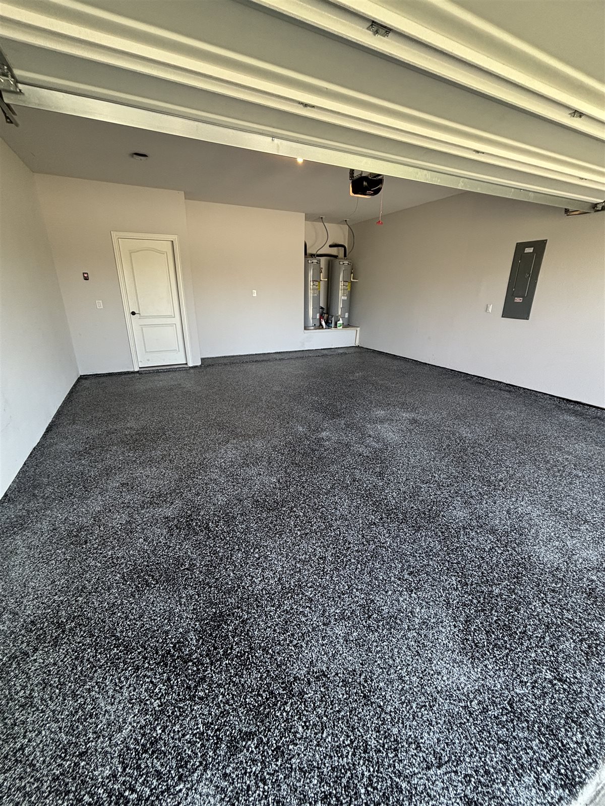 Finished dark flake epoxy garage floor in a Mansfield, TX home