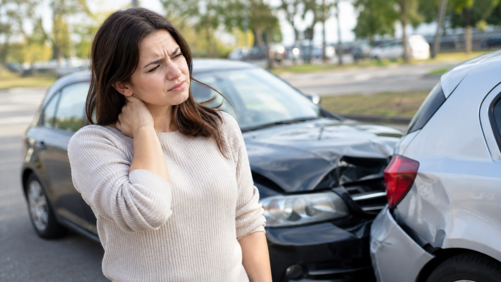 Person experiencing delayed neck and back discomfort after a car accident