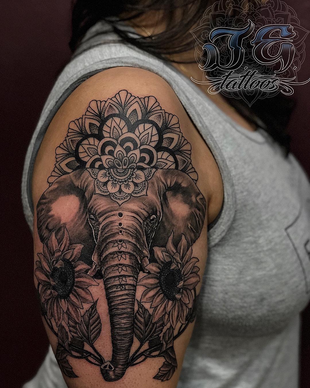 Elephant tattoo design featuring intricate mandala patterns and sunflowers on a woman's shoulder, showcasing the artistry of Jest Estevez at GameFace Tattoos.