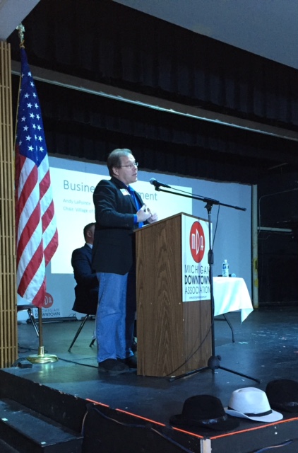 Andy LaPointe presenting at a Michigan Downtown Association podium