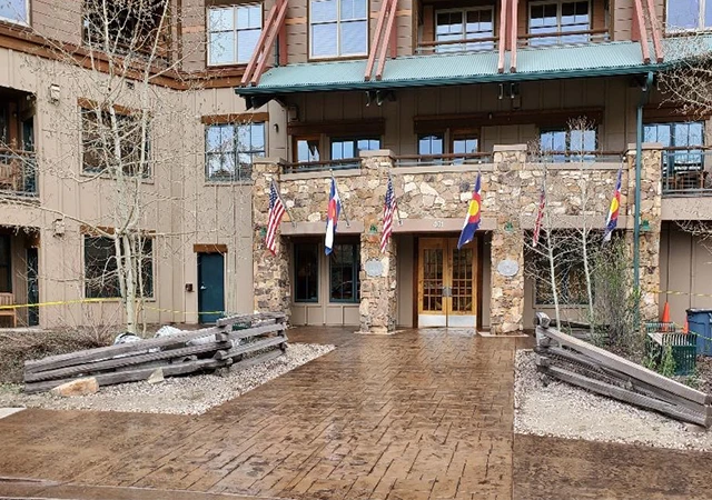 Architectural concrete patio with mountain backdrop, custom home build in Grand County Colorado