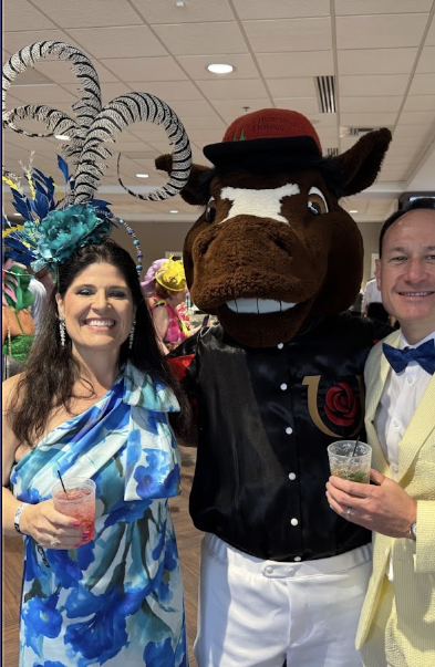 Gloria B. at the Derby wearing a custom Kat In A Hat peacock-feather statement fascinator