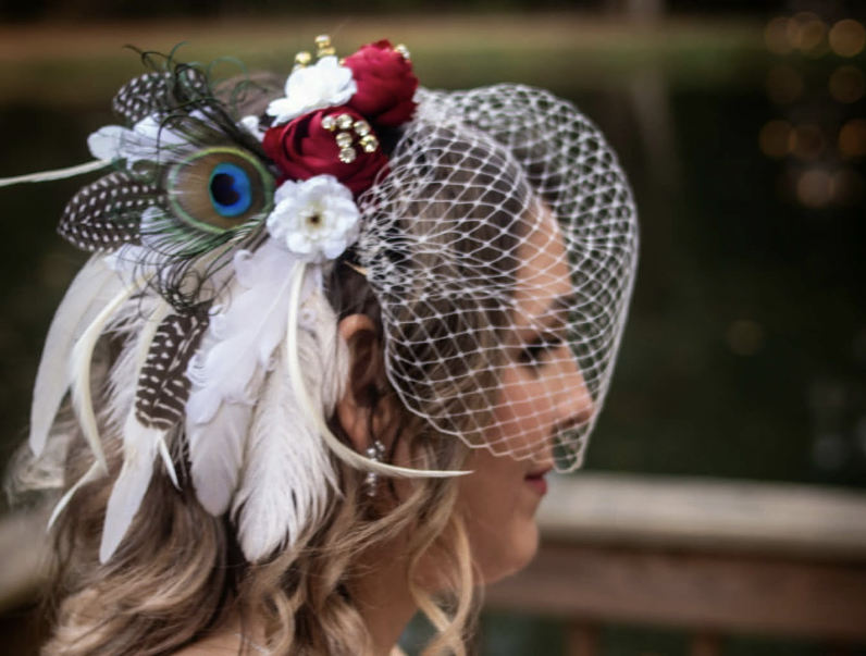 Michelle F. wearing a custom Kat In A Hat bridal birdcage veil with peacock feather and red rose