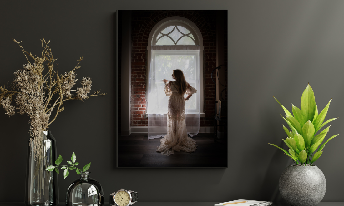 Wall art depiction of boudoir studio with moody lighting and vintage furniture