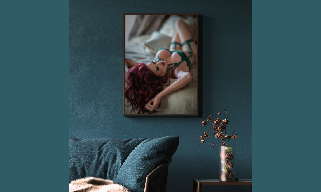 Wall art with Boudoir client laughing with hair tossed back on bed