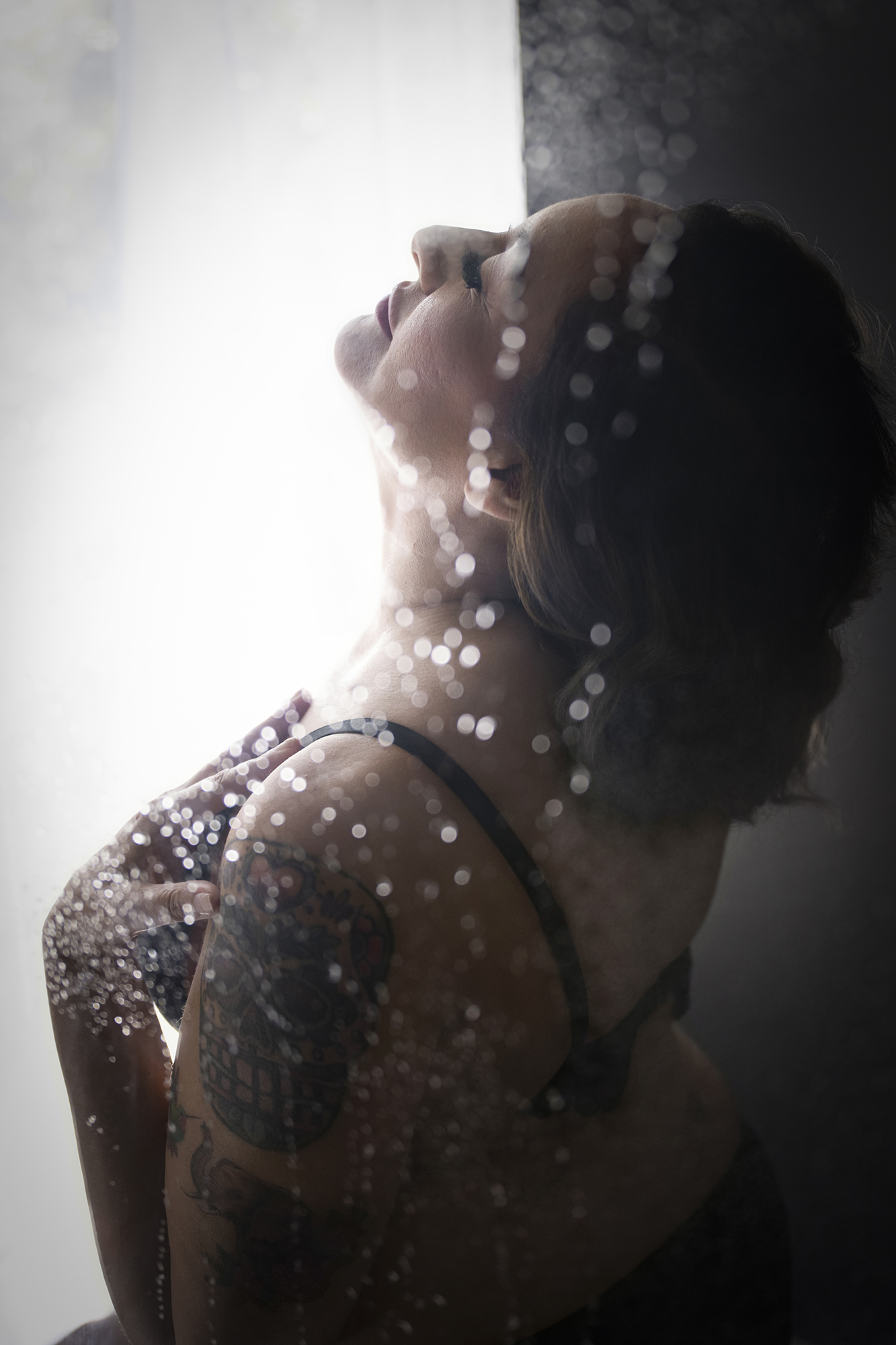faux shower image with boudoir client with tattoos on arm