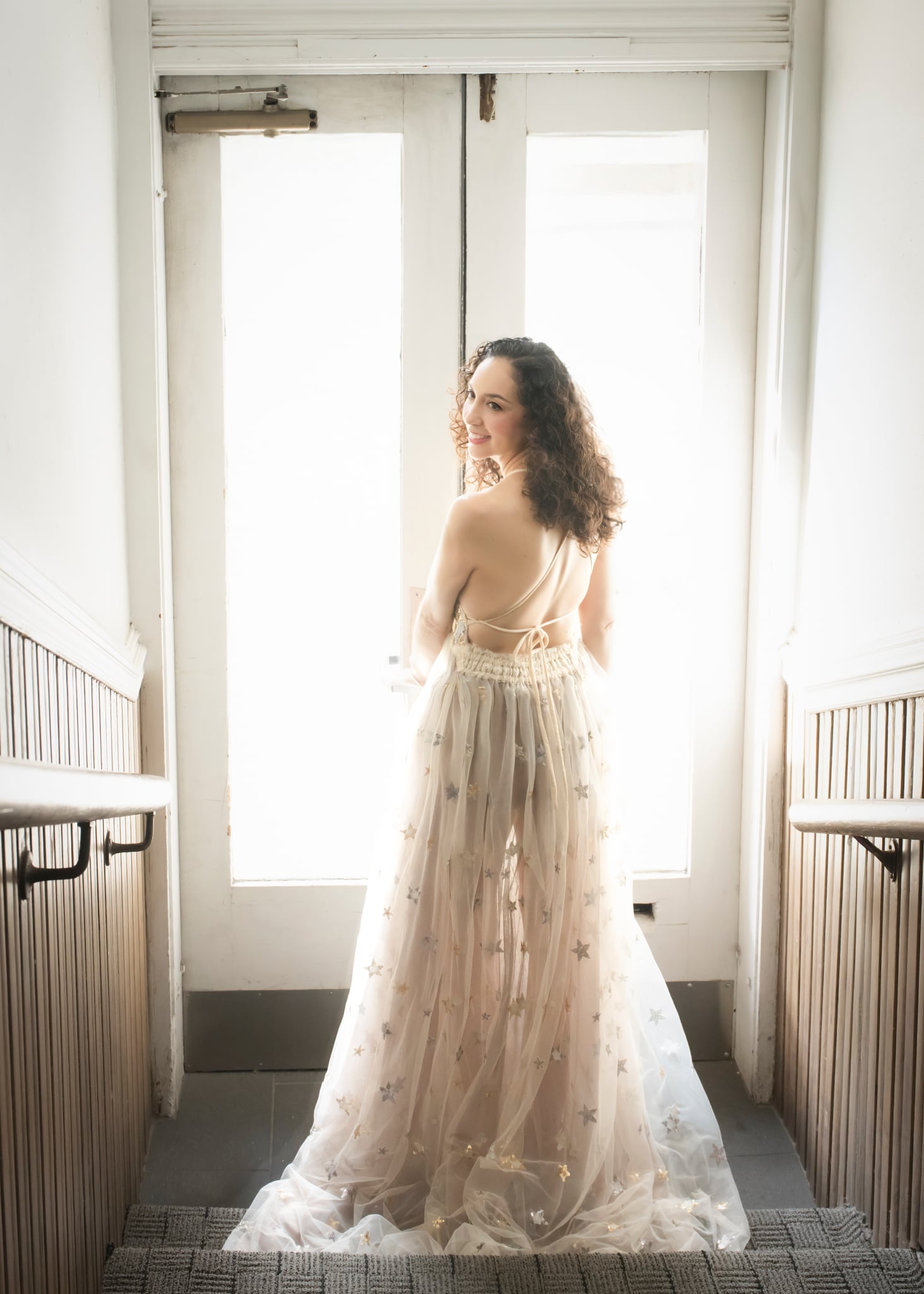 woman in delicate gown glowing in window light romantic boudoir portrait Pasadena by Barb Hauser Photography