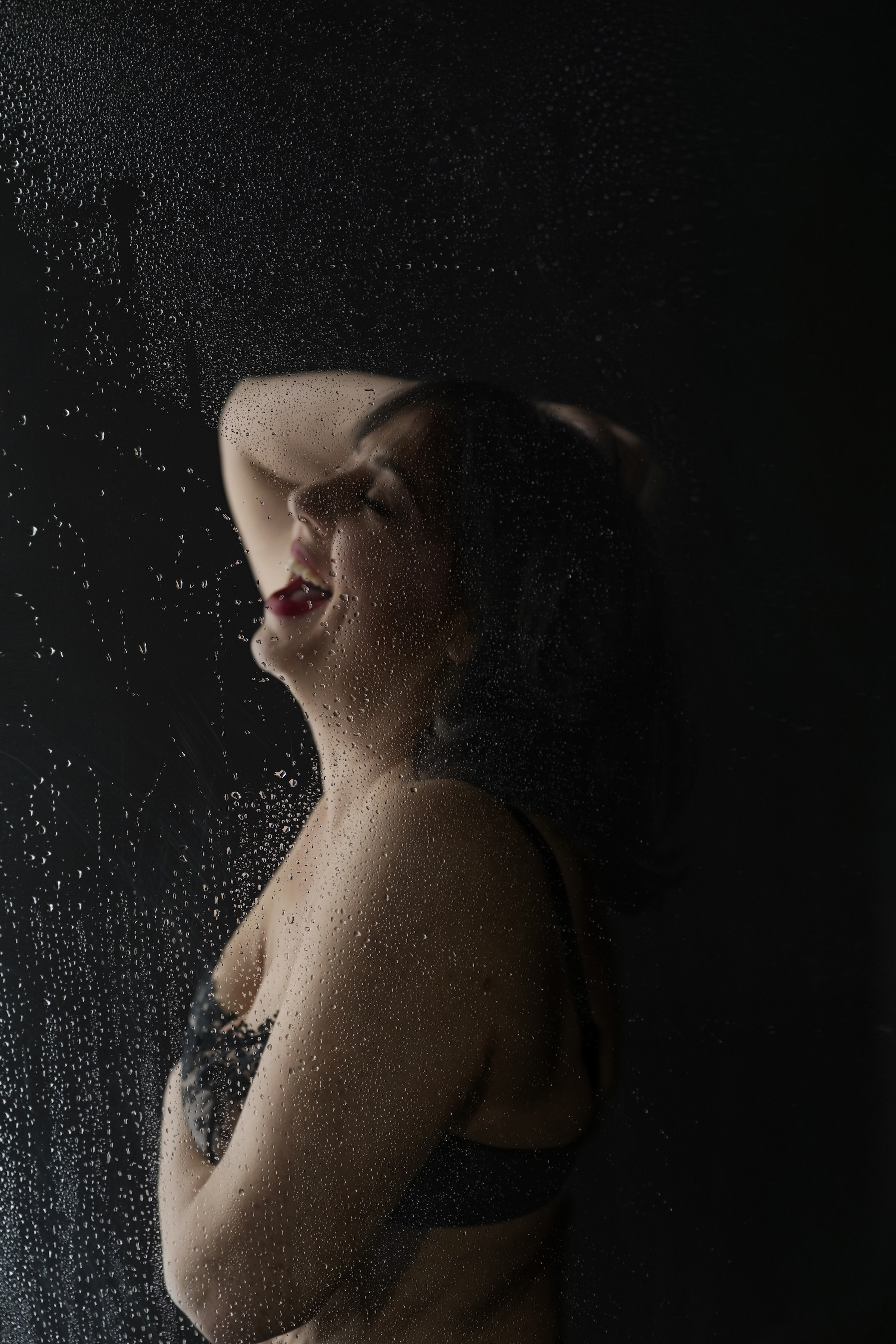 dark and moody shot with shower and laughing client by Barb Hauser Photography