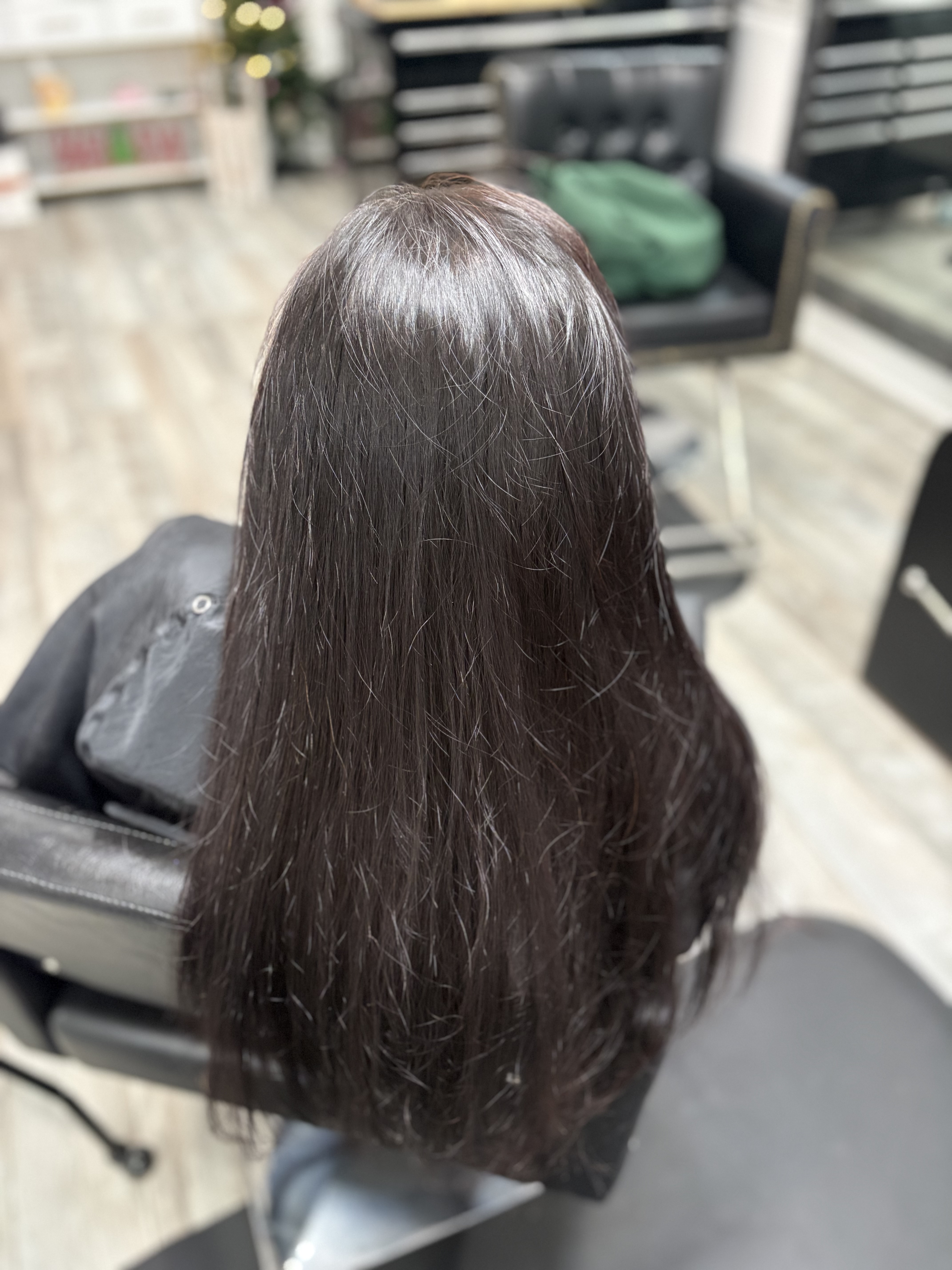 Long natural-looking brunette hair extensions by Beauty Empowered