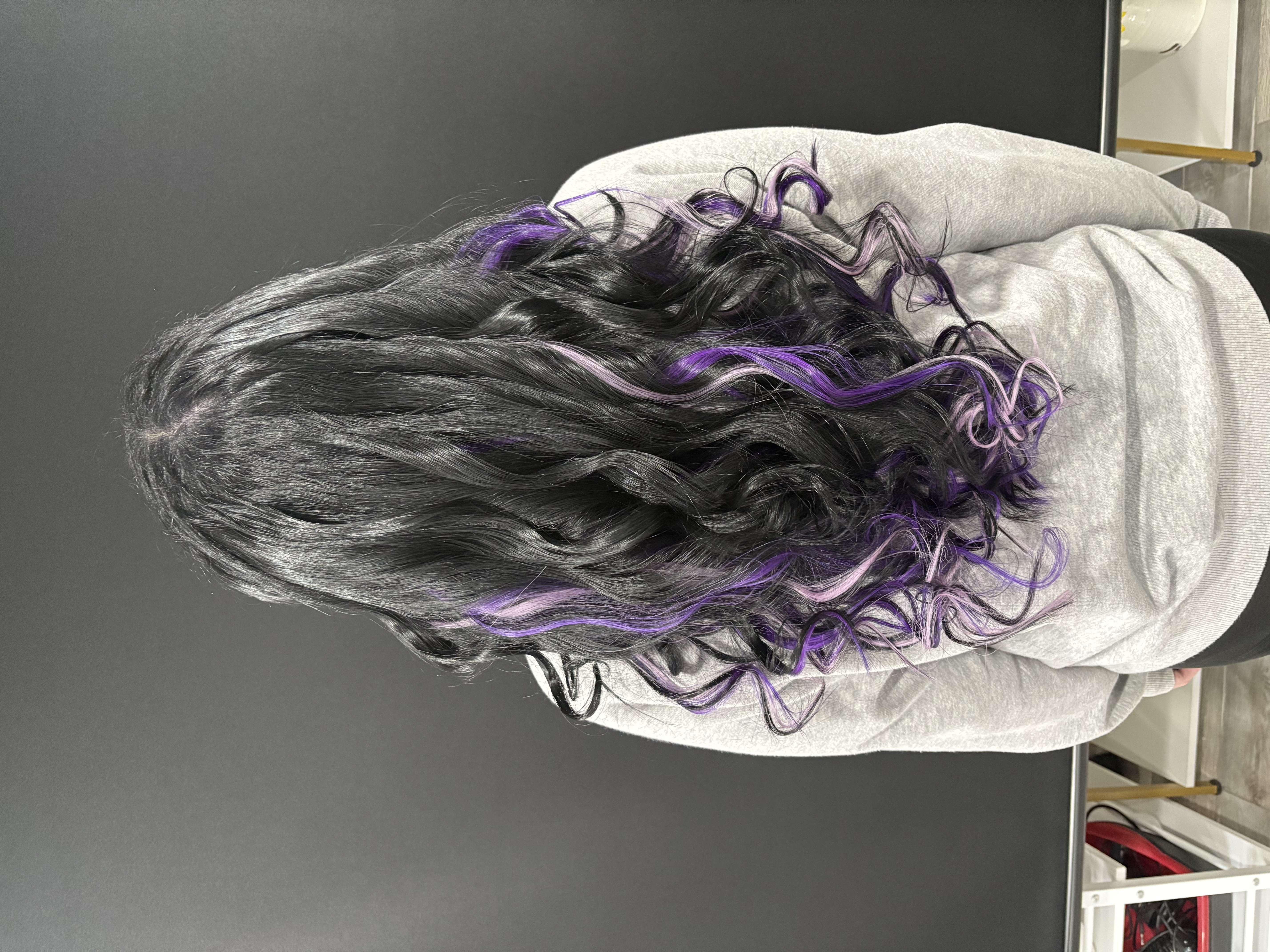 Black hair with purple fashion-color extensions by Beauty Empowered